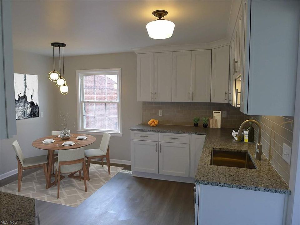 Kitchen with virtually staged seating area.