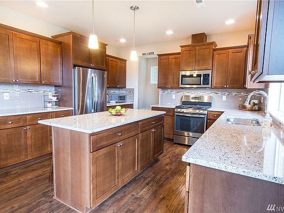 Spacious Gourmet Kitchen with loads of cabinet space and counter space. Gas oven & cook top! Microwave oven, French Door Refrigerator, and dishwasher. Under mount kitchen sink and granite counter tops!
