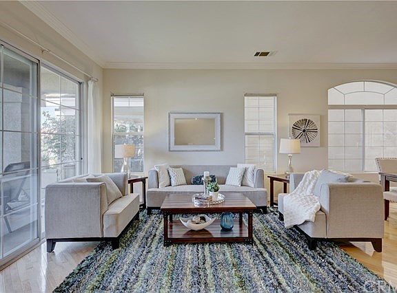 Bright and Light Formal Living room with Sliding Glass doors leading out to the front Patio