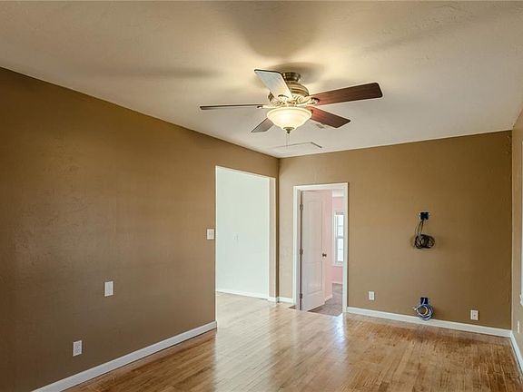Another view of the living room - 3rd bedroom is visible down the step - wiring is for surround sound. Kitchen and dining room are off to the left.