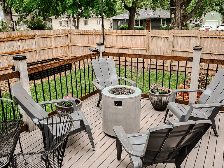 Back patio off kitchen with raised garden beds with water system.