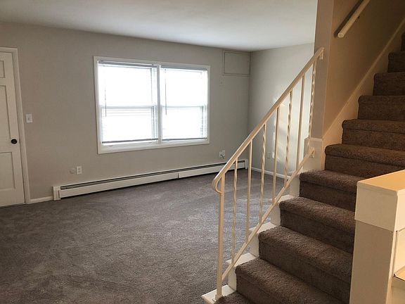 Livingroom with NEW carpet and stairs to the bedrooms and full bathroom.