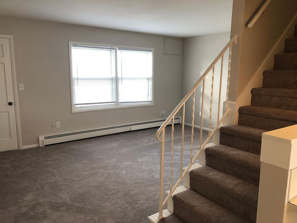 Livingroom with NEW carpet and stairs to the bedrooms and full bathroom.