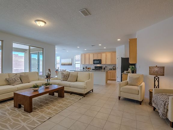The gathering room has gorgeous tile flooring with a large glass window overlooking the covered patio.