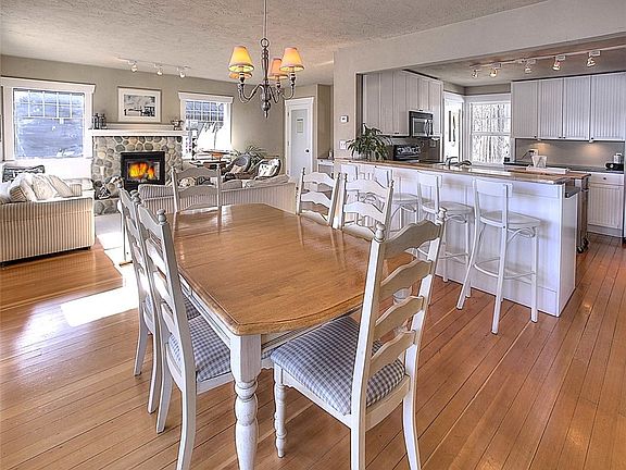 View from the dining area looking towards the great room and kitchen.  Not pictured to the left are french doors that lead out to the covered deck.