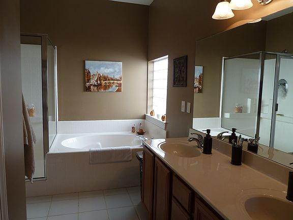 dual sink, shower/tub, tile floor