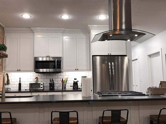 State of the art kitchen. Dishwasher, professional stove and hood, granite counter top.