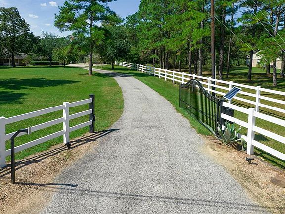 Gated entrance to the property with PVC fencing.