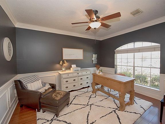 Formal dining room with rich color, wainscoting and crown molding.
