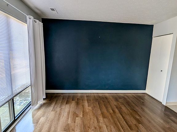 First floor dining room with sliding doors to patio; great natural lighting (with utility closet containing new hot water tank)