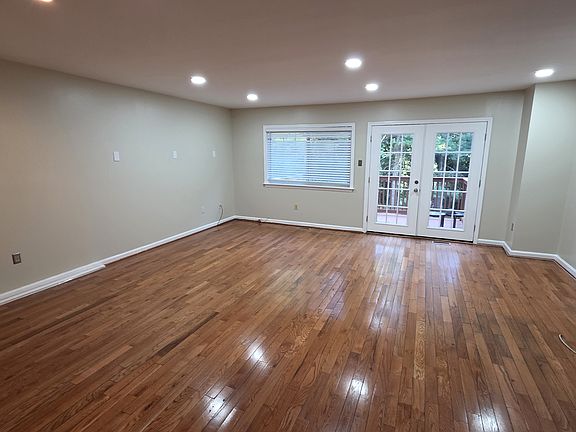 Spacious Living Room Wood Floors Patio door to the Deck that back to Trees