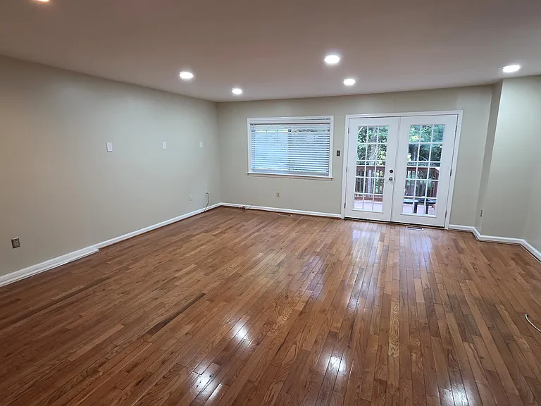 Spacious Living Room Wood Floors Patio door to the Deck that back to Trees