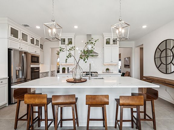 Kitchen with stacked glass-front upper cabinets over solid lowers