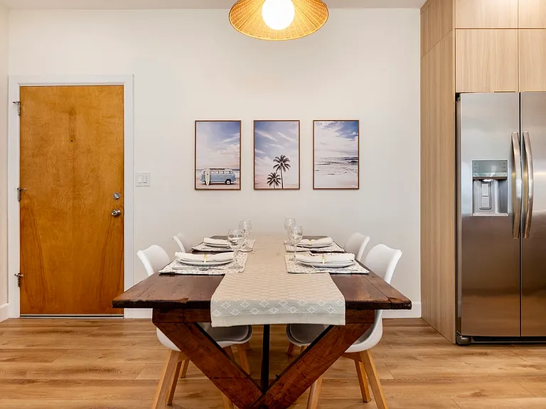 Inviting dining area with seating for four and warm pendant lighting.
