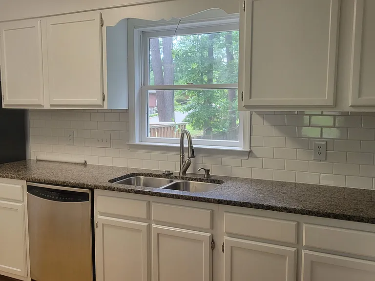 Window over the sink looks out over the large fenced yard.
