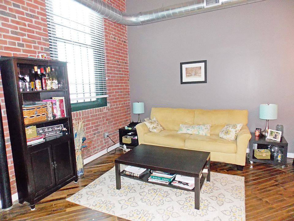 Open concept living room, with two large windows