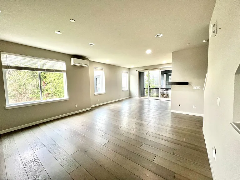 Living room with ample sun light and view of green space
