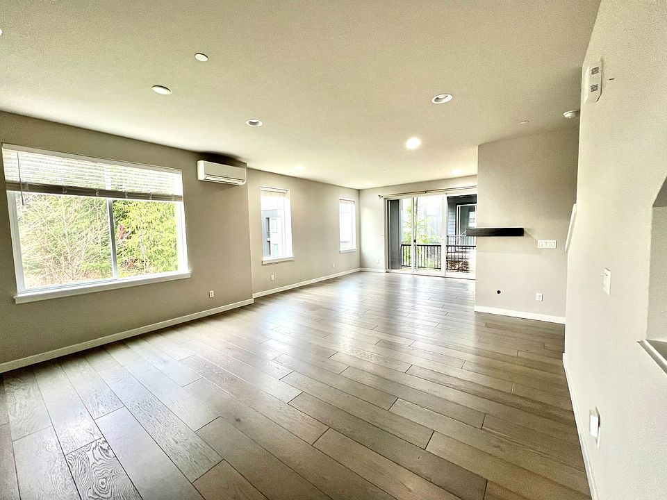 Living room with ample sun light and view of green space