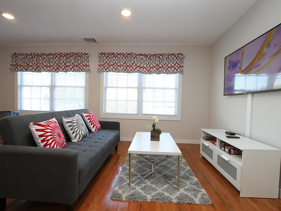 Comfortable living area with hardwood floors and recessed lighting