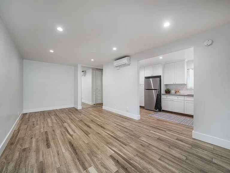Unit 9 studio with view of kitchen & wardrobe closet