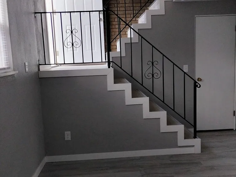 STAIRWAY TO THE LIVING ROOM. NEW FLOORING & NEWLY PAINTED.