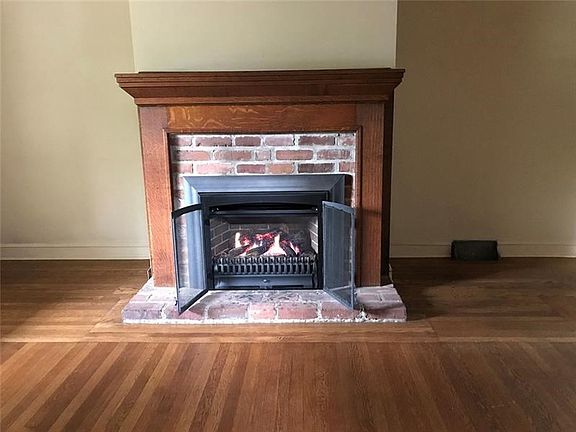 Living room fireplace holds a Valor radiant fireplace, simulating a wood fire and providing a heat backup during a power shortag