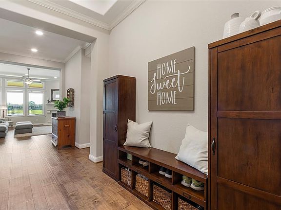Entering through the front door, what incredible architectural details, lviews all the way to the water! Lots of crown molding, hand-scraped engineere