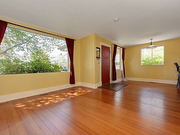 Spacious front living and dining area with southern exposure and fir floors.