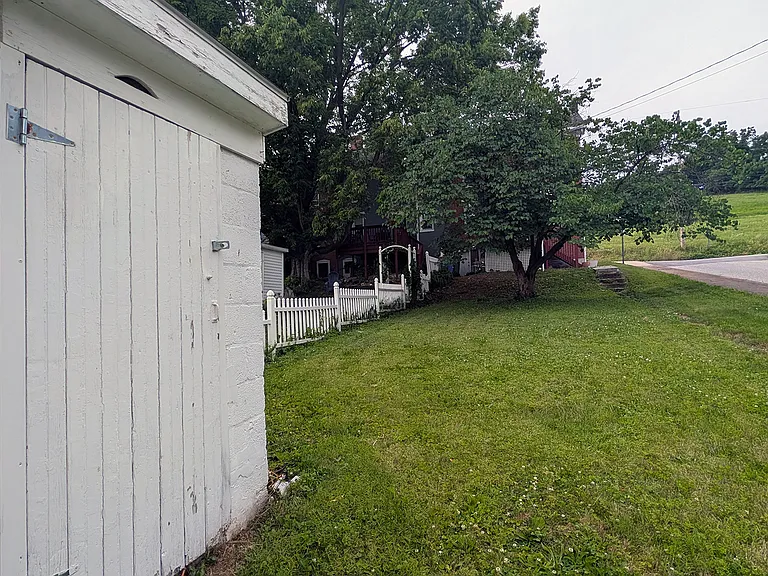 A garden shed is attached to the garage. I was once an outhouse, notice the moon window above the door, before the 1950's.