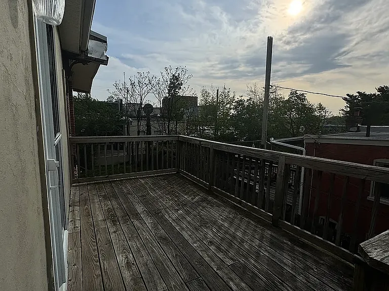 spacious deck overlooking the yard with a fire escape staircase