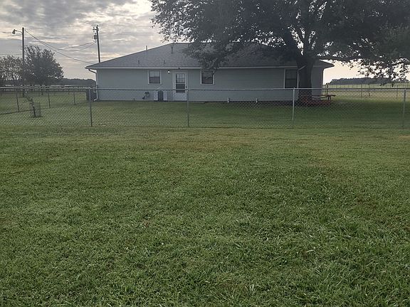 Back of house. Large live oak tree and large fenced back yard.