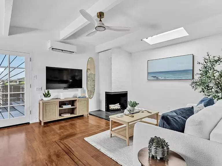 Cozy living room with a TV and a lovely fireplace