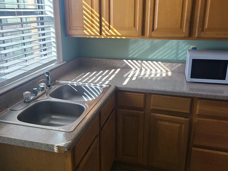 Kitchen sink, cabinets and microwave