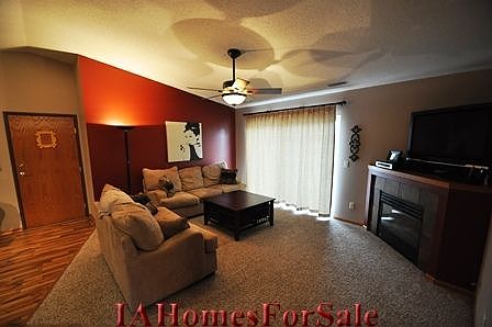 Living Room with new plush carpet and stone around the fireplace