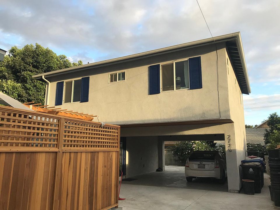 3BR, 3Bath modern back house on large lot - car port has one parking space available that is shared with front house. 2 entrances: one under the car port to downstairs bedroom/bathroomw, and one around the back from back patio. Entire back patio space is