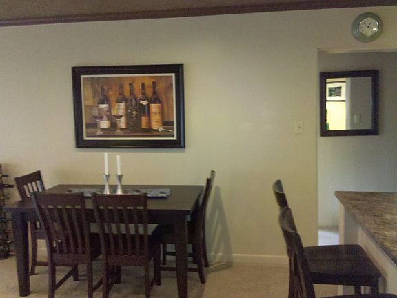 View from front door, dining room, kitchen island and hallwa