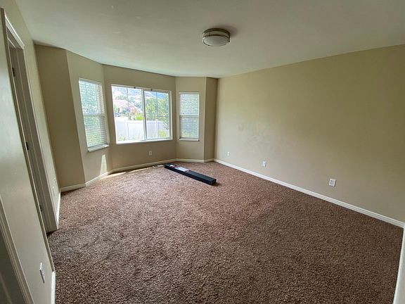 Master bedroom with bay window and mountain view.