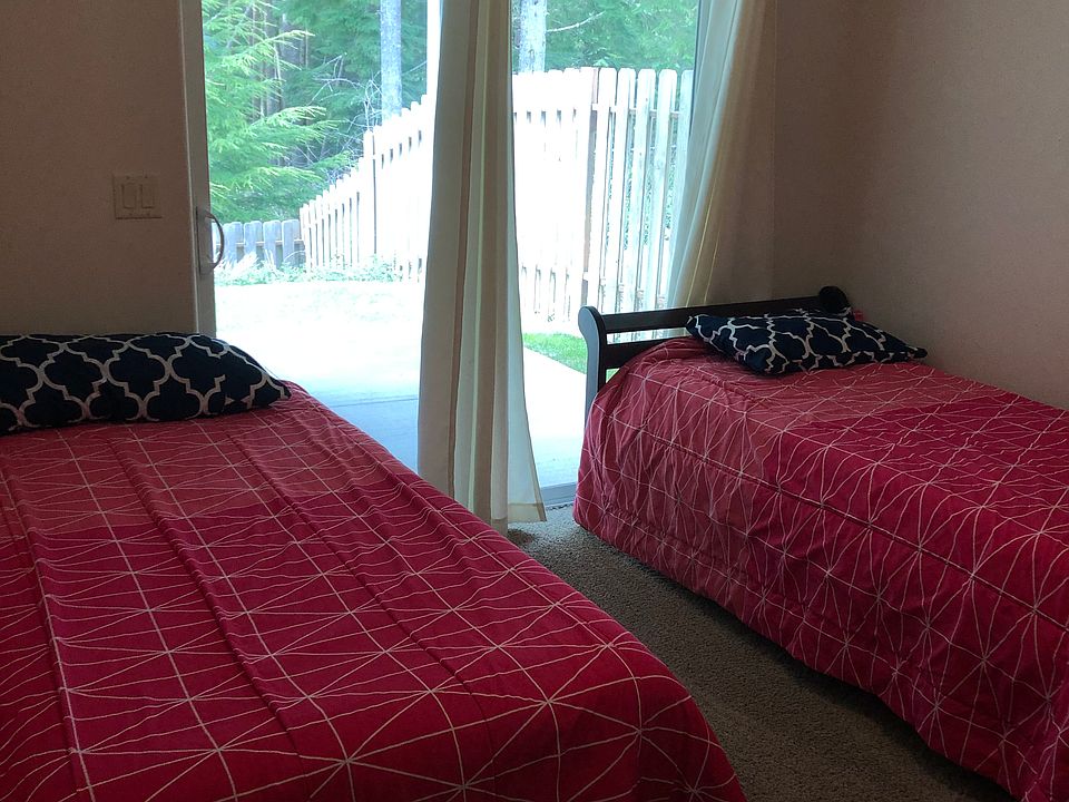 Bedroom 3 has the option of one or two single beds and opens to the back porch.