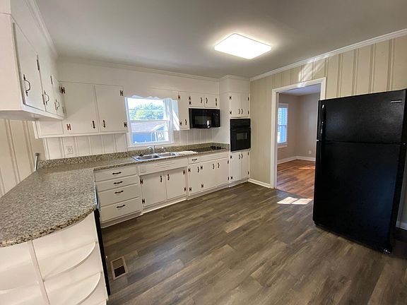 Massive open concept kitchen off the dining room and great room. Granite, new appliances including dishwasher, wall oven, smooth cooktop, dispose-all, ice maker. Look at those adorable shelves. Tons of natural light and LED work light.