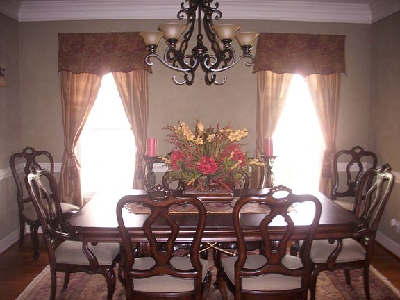 Formal dining room boasts hardwood floors, upgraded lighting & trim package.