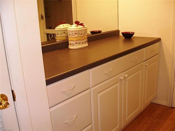 Custom built in cabinets along with added lighting create additional storage and counter space.