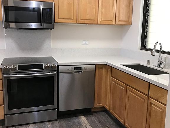 Kitchen - quartz countertops and SS appliances