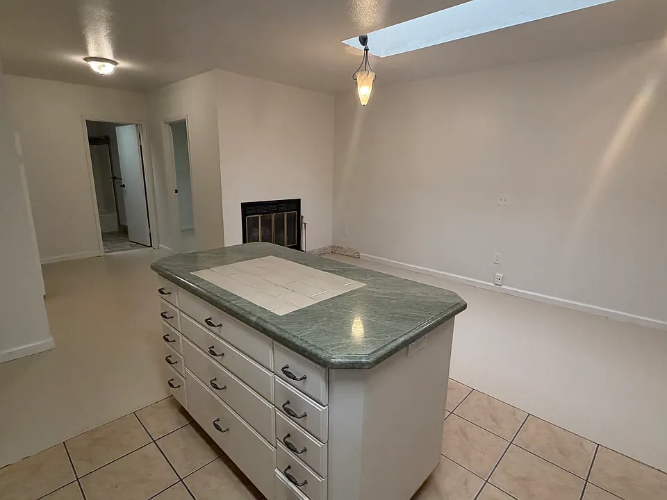 View from kitchen of open living area with opening skylight