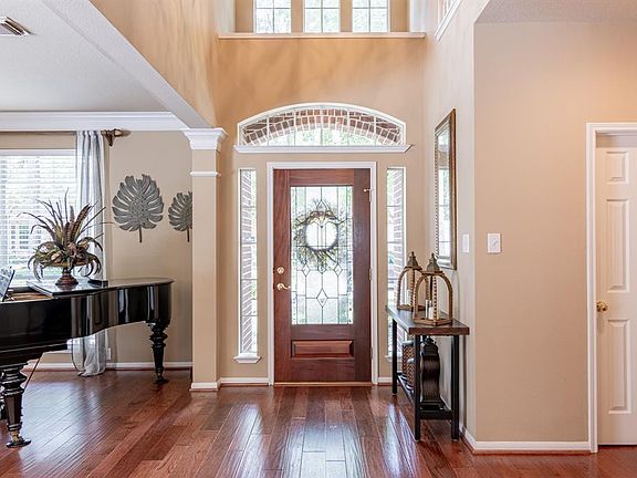 The stunning entry into the home boasts high ceilings and many windows to let in natural lights