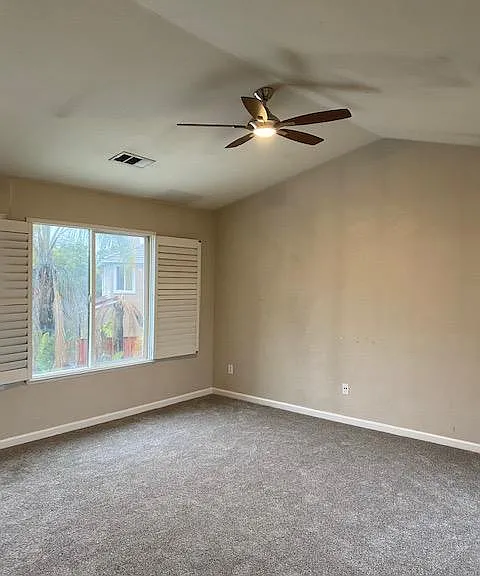 Master bedroom with large windows and new carpet