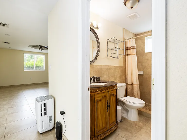 Bathroom and hallway from entry and leading to bedroom