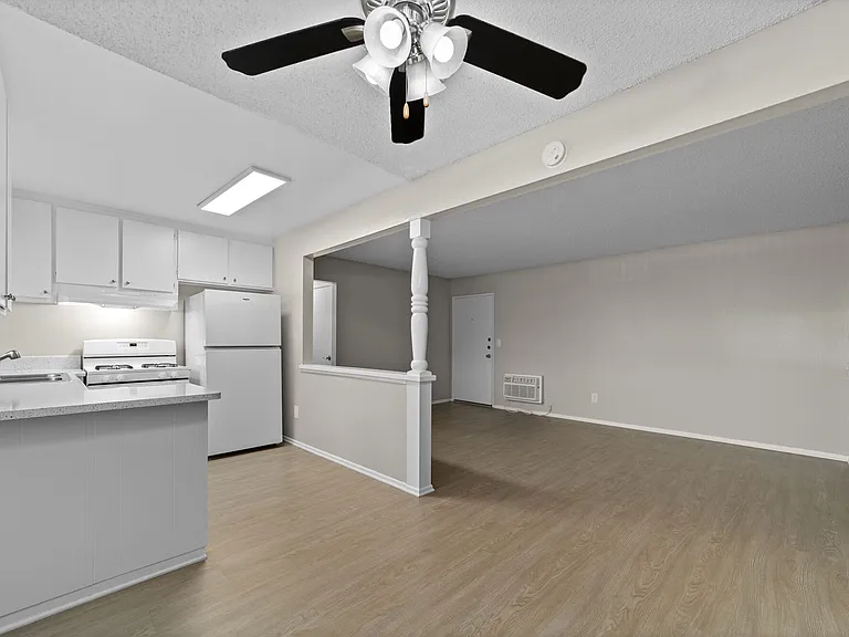Apartment living space, dining room, and kitchen at Strada Apartments in Orange, CA