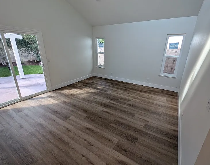 spacious master bedroom with sliding door to the backyard