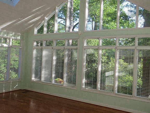 large sun porch with skylights spans the rear of the home