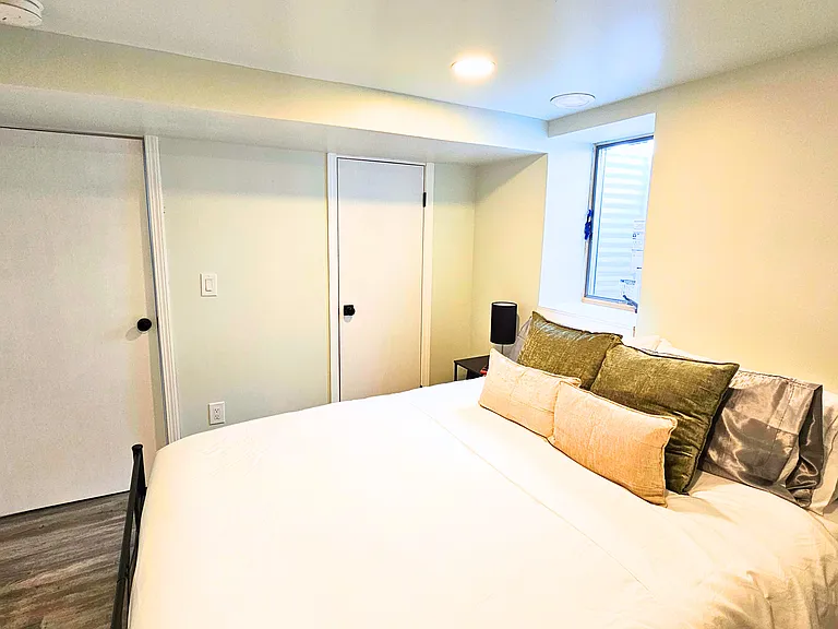 Lower level bedroom with queen bed and roku TV